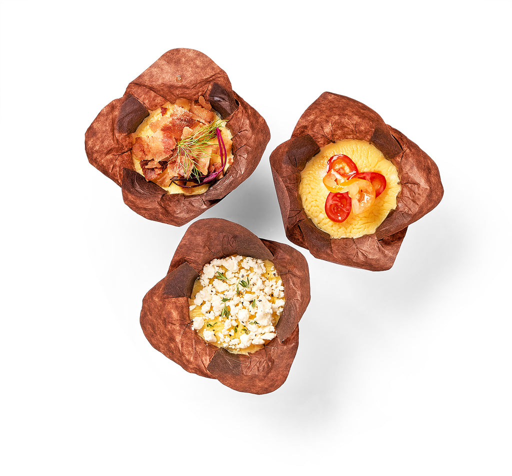 Three brown paper cups with Mini Frittata Muffins in them.