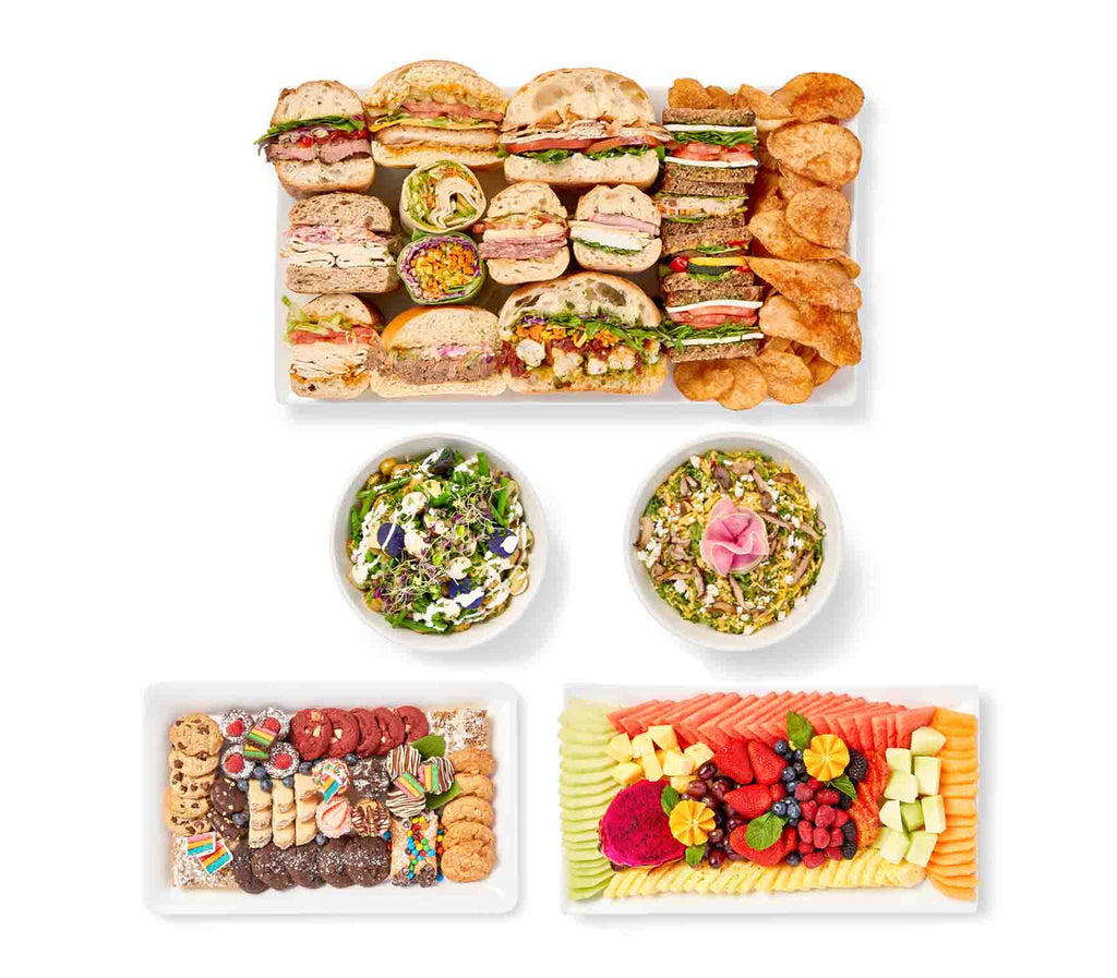 A Boardroom Lunch offering an assortment of sandwiches, salads, and fruit with accompaniments.