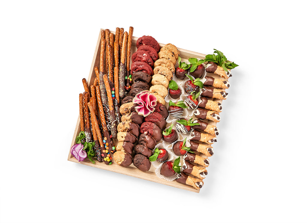 A wooden tray with a variety of Chocolate Lovers Platter, chocolate dipped cookies, and pretzels.