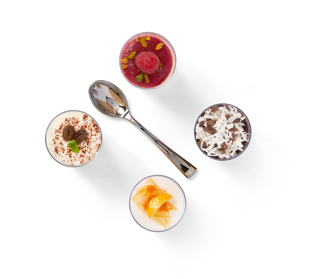 Four Tiramisu and Mini Mousse Shooters desserts with a spoon on a white background.