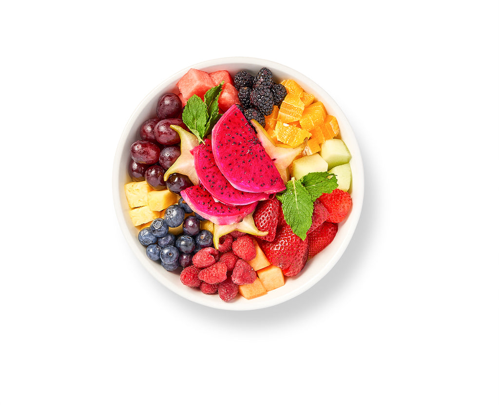 A bowl of Fresh Fruit Salad on a white background.