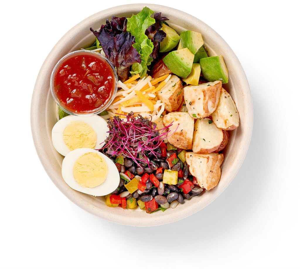 A South of the Border Breakfast Bowl with a salad, griddled potatoes and tomatoes.
