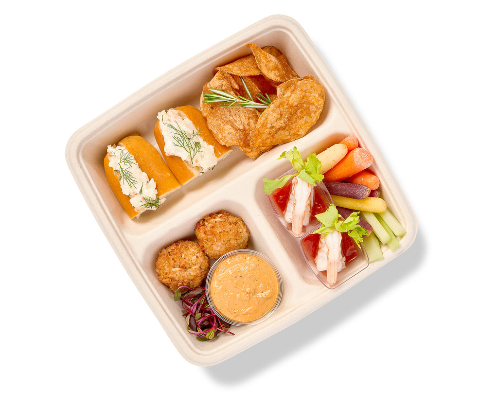 A Seafood Themed Snack Box with a variety of Mini Crab Cakes and dips.