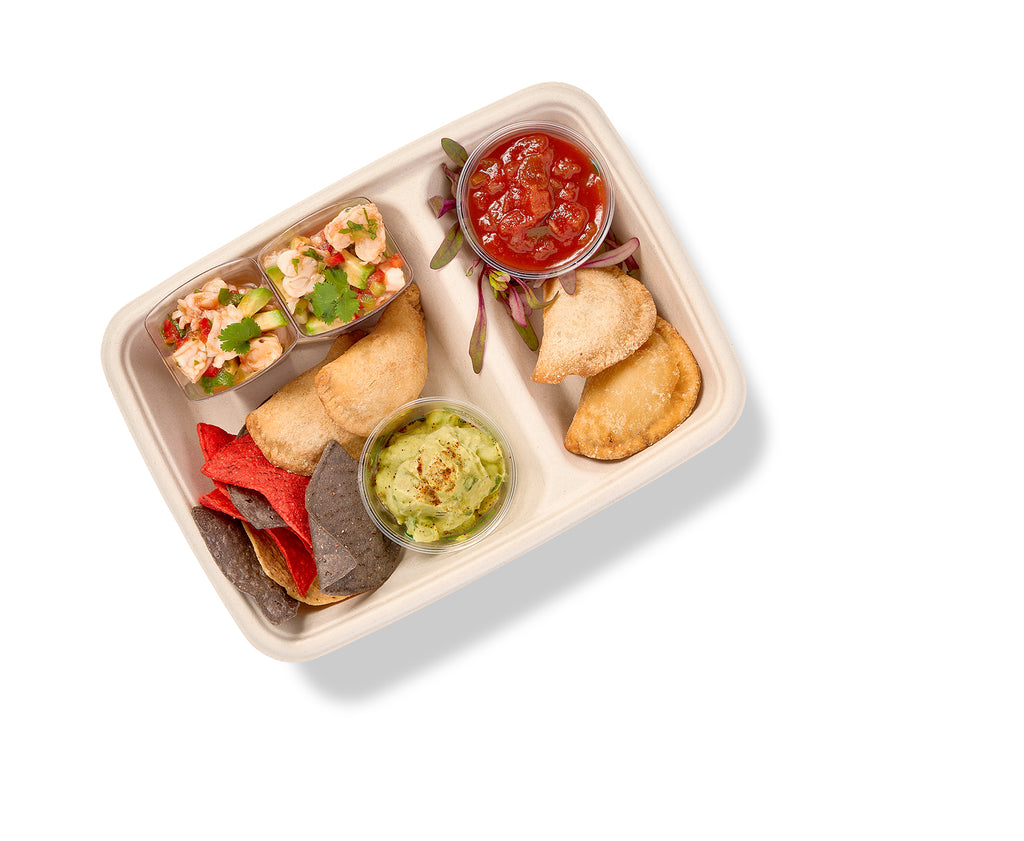 A Southwest Themed Snack Box with Tortilla Chips with Guacamole and salsa.