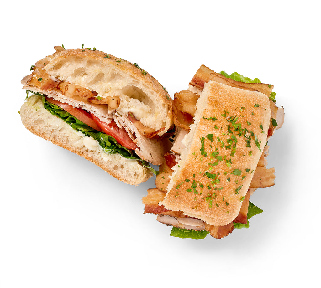 Two Grilled Chicken BLT Sandwiches on a white background.