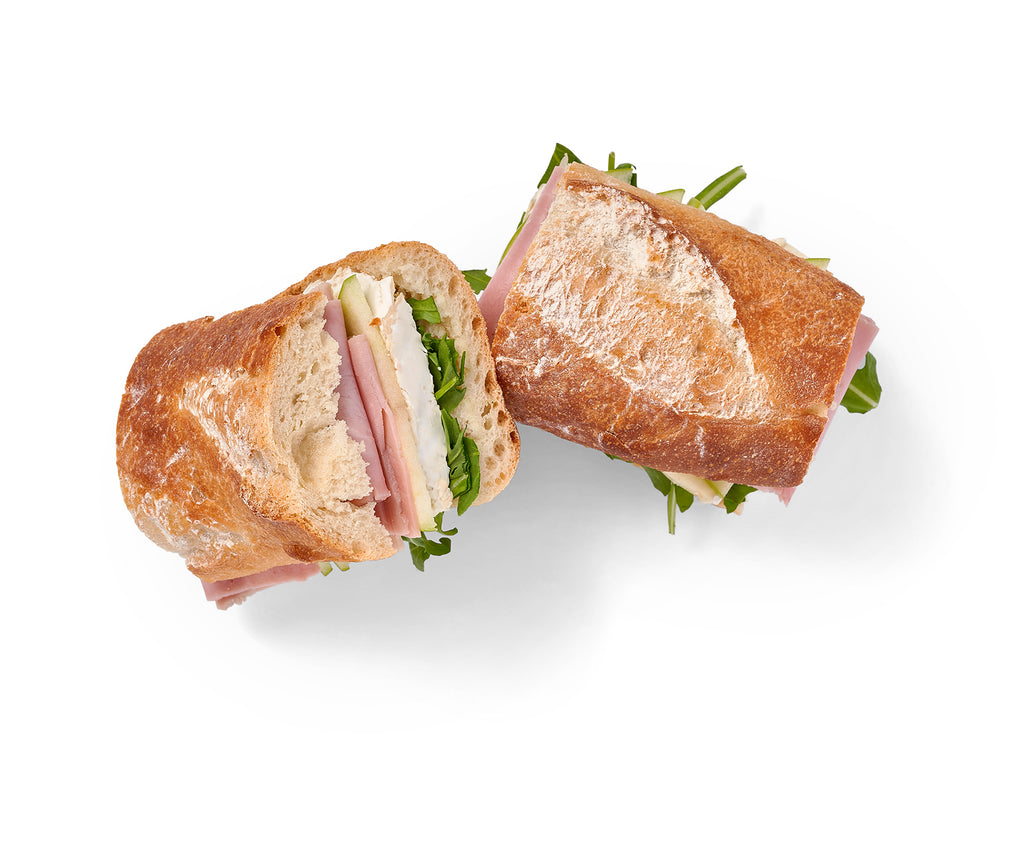 Two Honey Roasted Ham Sandwiches on a white background.