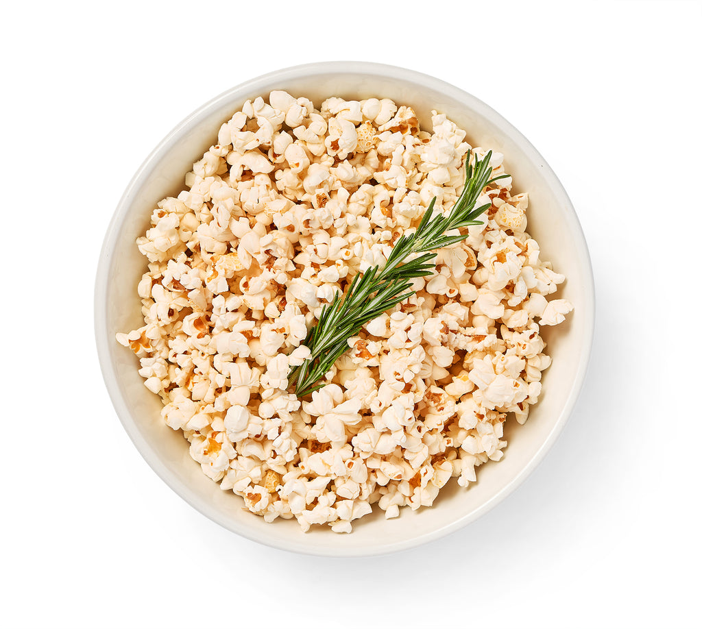 Spiced popcorn in a bowl on a white background.