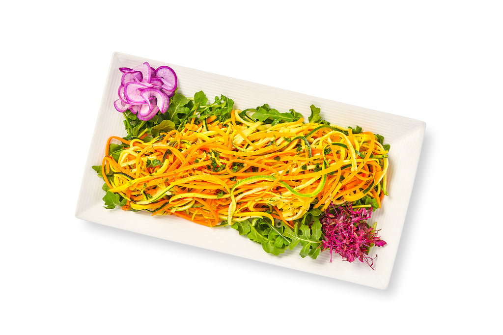 A white plate with a colorful sautéed julienne vegetables on it.